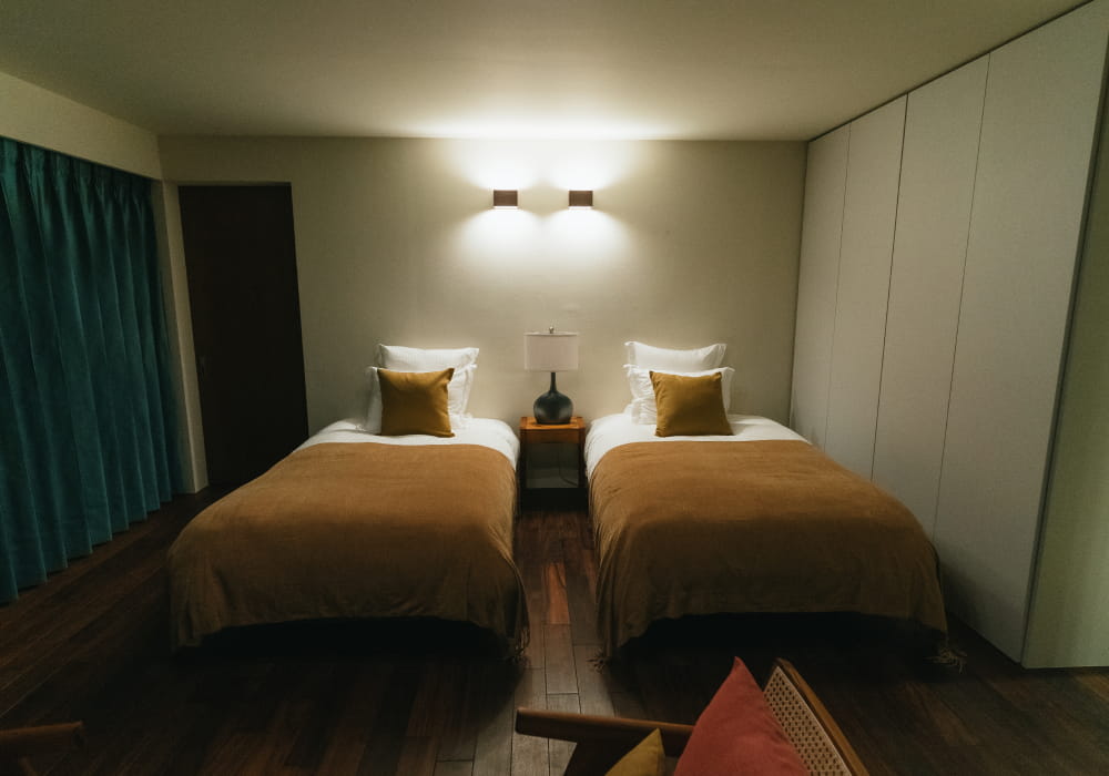 木の風合いに包まれた、ツインタイプのベッドルーム①