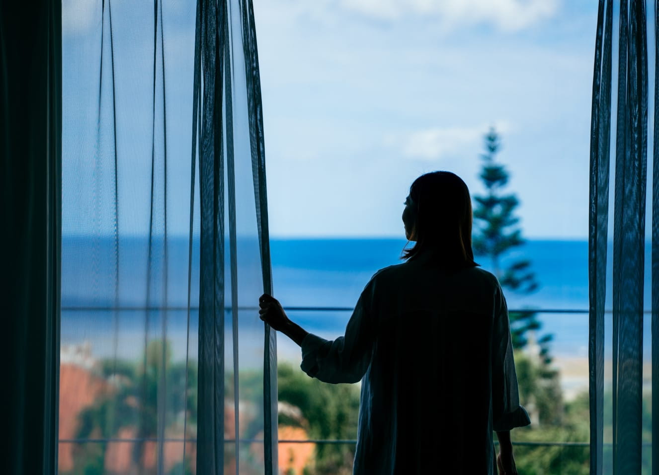Silhouette of woman gazing at the sea from inside GOKKAI SEITEI